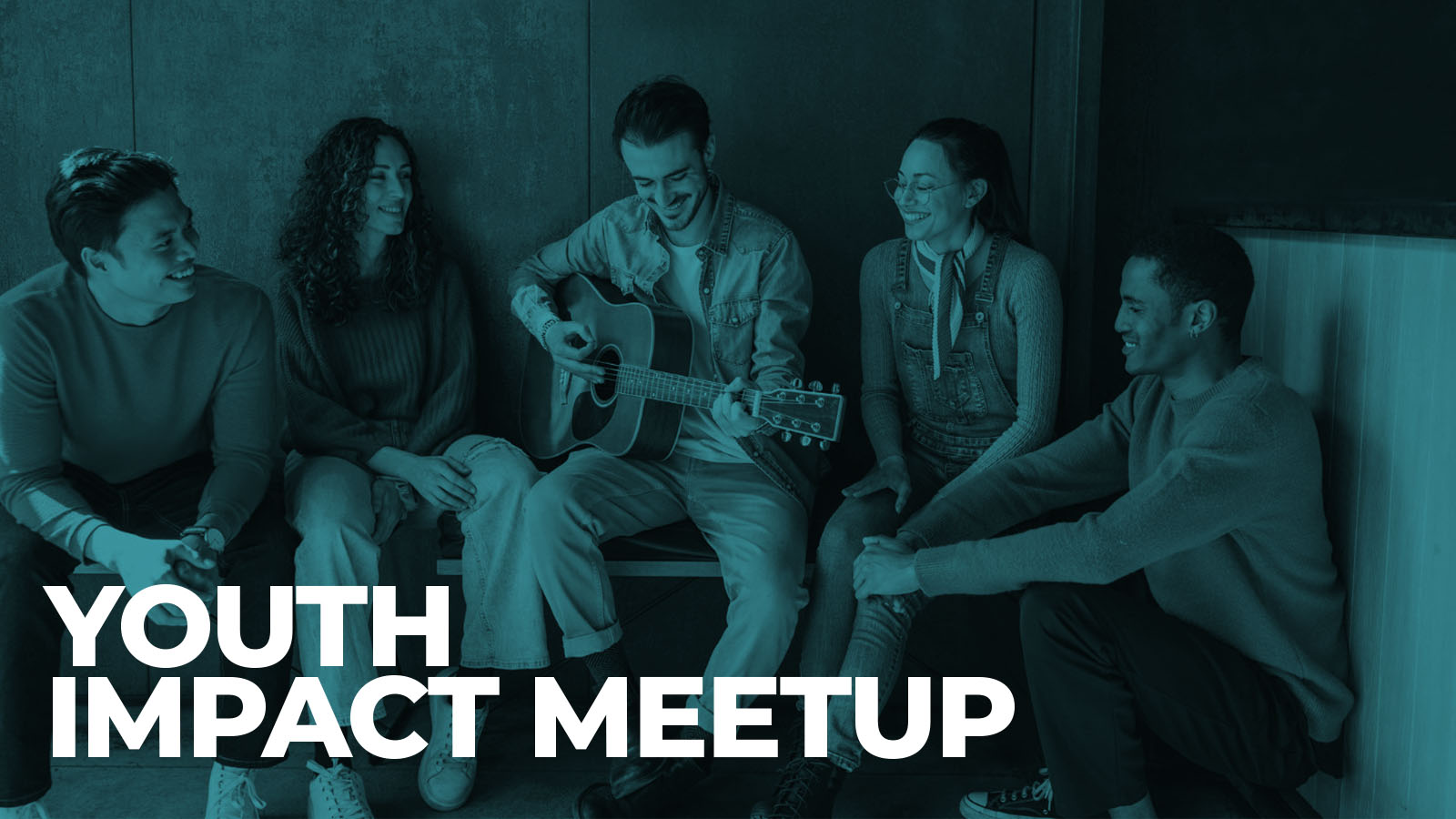 Young adults gather as one plays guitar at meetup